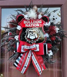 a wreath on the front door of a building that says bulldog nation and features a football helmet