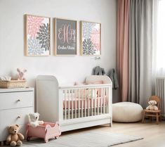 a baby's room with pink and gray decor, including two posters on the wall