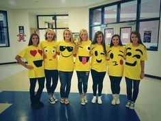 a group of young women wearing yellow shirts with emoticions on their chests