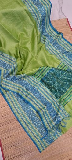 Primium quality Tussur Jamdani Saree,a masterpiece of the artwork from the Bengal weavers. Dyed Gachhi Tussur Saree,parrot green color with wide Blue Reshom thread weaving border.Jamdani weaved Pallu ends with cotton tussels. Saree will give you authentic traditional bengali look in Durga puja ,festival or weeding. Light weight comfortable saree. Comes with running blouse piece. Silk mark certified product. Please note thread pull and thread missing are bery common in handwoven sarees as they are completely handcrafted items weaved in traditional weave or Tant.Intricate designs required hardship of the artists. This will not be considered as Damage. Due to digital photography color may vary a light. Please check availability before placing order. Green Slub Silk Traditional Wear With Traditional Drape, Green Slub Silk Traditional Wear With Pallu, Green Cotton Silk Traditional Wear With Drape, Green Cotton Silk Dupatta, Green Handloom Raw Silk Traditional Wear, Green Raw Silk Handloom Traditional Wear, Green Cotton Silk Traditional Wear For Festivals, Green Handloom Raw Silk Dupatta, Green Handloom Cotton Silk Saree