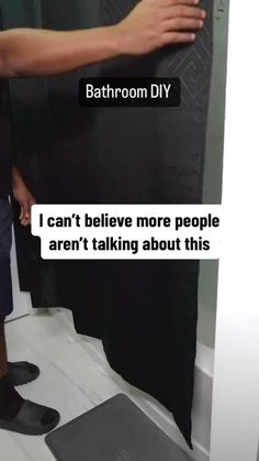 a person standing in front of a shower holding onto a black curtain with the words, i can't believe more people aren't talking about this