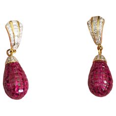 This wonderful Fabergé earring piece is a neo- vintage and has never been worn. This beautiful piece is crafted in Thailand using 18K yellow gold. The piece is adorned with numerous squared pinkish-red natural rubies and various good quality brilliant and baguette diamonds accent. It is an extremely difficult piece to make. A wonderful passionate ruby piece to add to your jewelry box. Wear with care: elegant wear only- Perfect for wear on any special occasions. 18K gold chain is included. We als Vintage Pear-shaped Formal Earrings, Vintage Pear-shaped Earrings For Formal Occasions, Yellow Gold Pear-shaped Earrings For Evening, Pear-shaped Yellow Gold Earrings For Evening, Elegant Wear, 18k Gold Chain, Pinkish Red, Baguette Diamonds, Yellow Gold Earring