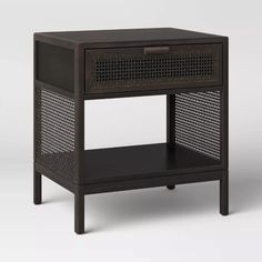 the side table has an open drawer on top and is made out of dark wood