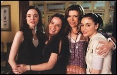 four women are posing for a picture together