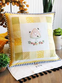 a pillow with a cake on it sitting next to a potted plant and other items