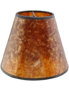 a lamp shade that is brown and has an orange pattern on the inside of it