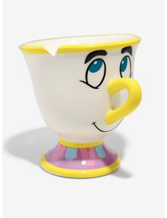 a cup with a face painted on it and a yellow handle is sitting in front of a white background