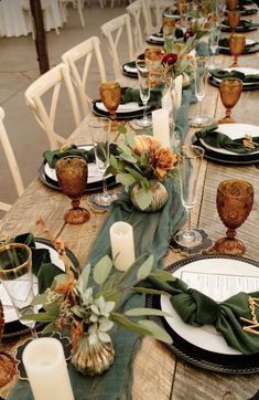 the table is set with place settings, candles and napkins for dinner guests to enjoy