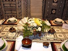 the table is set with dishes and place settings