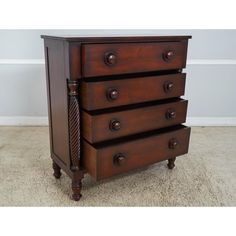 a wooden dresser with four drawers on it