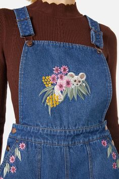 Denim embroidered overall- featuring the cutest embroidered Greater Glider hiding amongst lush Australian flora- a easy relaxed overall style to layer over any top- bib & brace bodice- wide leg cut- handy side pockets- button opening at side and adjustable shoulder straps- made of a cotton denim- available in blue mid denim Product Code: PGFX415