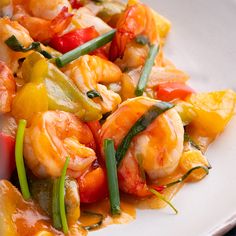 a white plate topped with shrimp and veggies