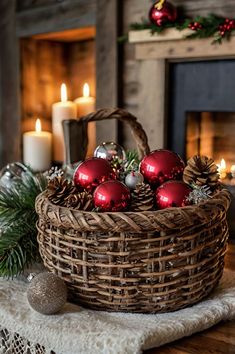 a basket filled with christmas ornaments on top of a table next to a fire place