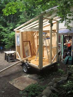 a small shed is being built in the woods