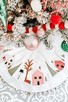 a christmas tree skirt with ornaments on it