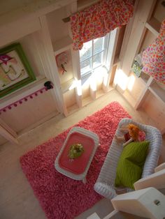 a small child's bedroom with bunk beds and pink rugs