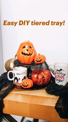 a wooden table topped with pumpkins and other halloween decorations next to a cup filled with coffee