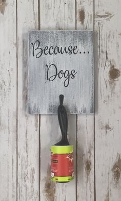 a sign that says because dogs is on the wall next to a cup with sauce in it