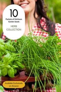 a woman holding a tray filled with lots of green plants