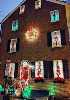 a house decorated with christmas lights and wreaths