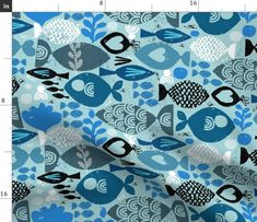 a blue and black fish pattern on a light blue background, with small white dots in the center