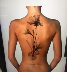 the back of a woman's body with flowers on it