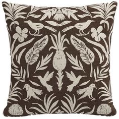 a brown and white pillow with birds, flowers and leaves on the front in an ornate pattern