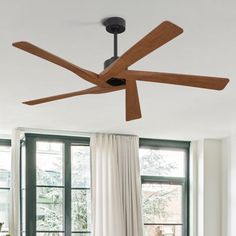 a living room with a couch, table and ceiling fan in the middle of it