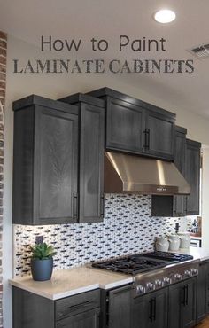 an image of a kitchen setting with black cabinets and white counter tops, wood flooring