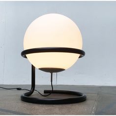 a lamp that is sitting on top of a stand with a light bulb attached to it