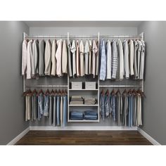 an organized closet with clothes hanging on rails