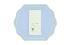 a blue and white plate with a flower on the side, along with a light blue border