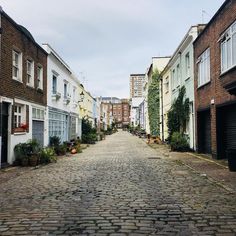 a cobblestone street lined with brick buildings