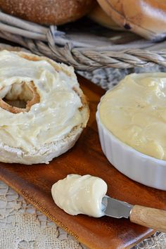 a wooden tray topped with bread and cream