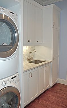 a washer and dryer in a laundry room next to each other on the floor