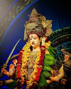 an idol is displayed in front of a blue background