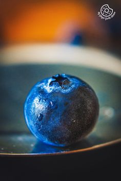 a blueberry sitting in a metal bowl