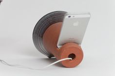 an ipod is hooked up to a spool of cord