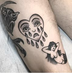 a couple of tattoos that are on someone's leg and one is holding a heart