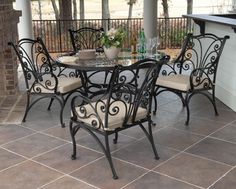 an outdoor table and chairs on a patio