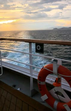 the deck of a ship at sunset with life preserver on it's side