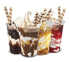 four different types of ice cream sundaes in plastic cups