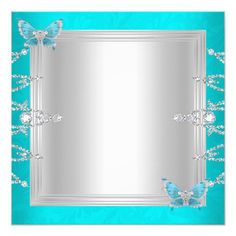 a blue and silver frame with two butterflies on the border, in front of a turquoise background