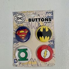 three button badges in the shape of batman and superman logos