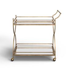 a gold serving cart with glass shelves and wheels on the bottom shelf, against a white background