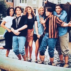 a group of people standing next to each other in front of a fire hydrant