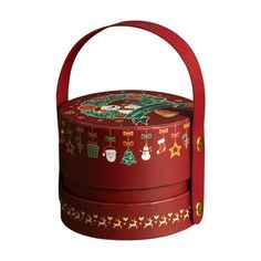 a small red box with christmas decorations on the lid and handle, sitting in front of a white background