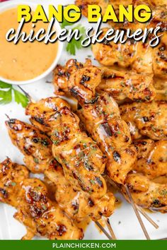 grilled chicken skewers on a plate with dipping sauce