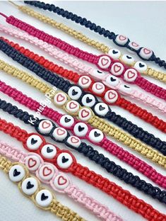 five bracelets with eyes and hearts on them