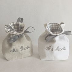 two small bags with the words mrs and mr suckle on them are sitting next to each other